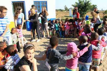 The teen tour group, myself included, playing circle games with the kids in South Africa!